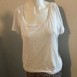 T-shirt boasting a graceful scoop neckline and solid hue that's easy to match.